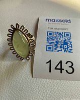 Ring front showing prehnite stone and scalloped border