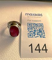 Front view of sterling silver ring with ruby cabochon and 144 slip