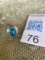 Front view of sterling silver ring with oval turquoise cabochon