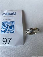 Ring beside lot tag showing overall appearance