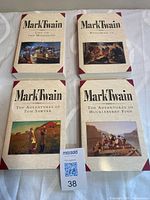 Front covers of all four Mark Twain paperbacks displayed