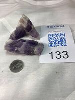 Three laser-form amethyst crystals with coin for scale and lot card