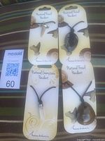 Group shot of four packaged fossil pendants