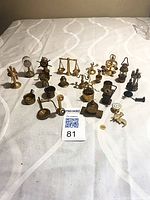 Group shot of 22 brass miniatures on table with lot card