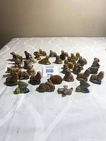 Group of 35 Wade animal figurines arranged on table