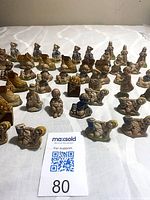 All 48 Wade nursery rhyme figurines laid out on table