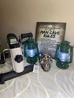 Group shot showing pedal exerciser, two lanterns, skull, and Man Cave Rules sign