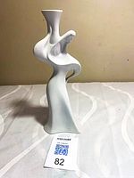 Front view of white porcelain abstract female figurine