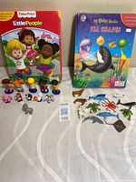 Both My Busy Books with figurines laid out on table