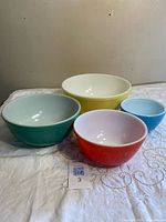 Four coloured Pyrex bowls nested together