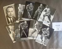 All ten player postcards laid out, showing images and signatures
