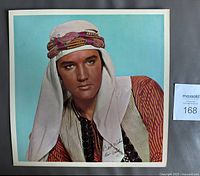 Front view of glossy Elvis Presley Harum Scarum insert print showing portrait and colors