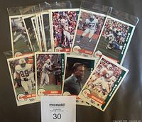 Front view of all 16 Miami Dolphins Police cards in sleeves