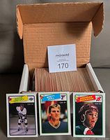 Open card storage box with visible stack of cards and front cards of Wayne Gretzky, Brett Hull, Brendan Shanahan