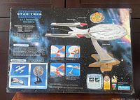 Rear of sealed retail box showing product features and contents