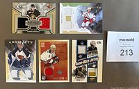 Front view showing all five game-worn jersey cards and their swatches