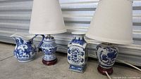 Group shot of three lamps showing pitcher, baluster and square forms with shades
