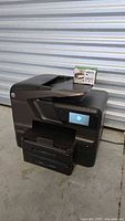 Front and side view of HP Officejet Pro 8600 Premium printer with ink pack on top