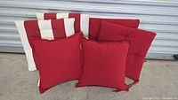 Six outdoor cushions arranged against metal door