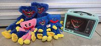 Group of six plush toys and mint aqua lunchbox