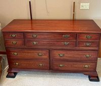 Front view of 10-drawer cedar dresser showing drawer arrangement and brass pulls