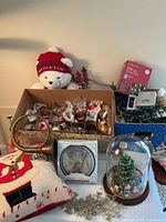 tabletop with ornaments box, teddy bear, pillow, clock, lights, glass dome figurine