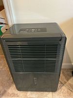 Front view showing digital controls and louvered grill