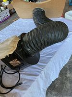 Motor housing with flexible hose and cloth bag