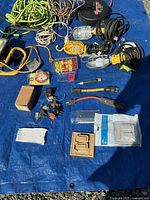 Overall view of cords, work lights, wire nuts, plugs and plates on tarp