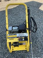 Front view of Karcher pressure washer showing frame, pump, specification plate and wand