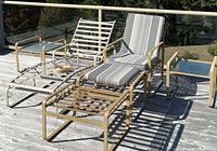 Overall view of patio furniture set including tables, lounge, chair, ottomans