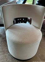 Front view of white upholstered barrel chair