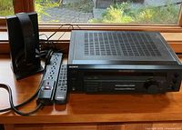 Sony receiver, headphone dock, remote and power strip on windowsill