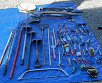 Full layout showing all long-handled and hand tools on blue tarp