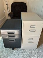 Black three-drawer cabinet and beige two-drawer cabinet side by side on carpet