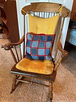 Front view of rocking chair with cushions and pillow