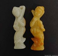 Front view of both jade figurines standing upright