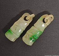 Front view showing both pendants, stone color gradation and carved details