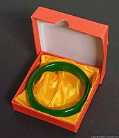 Bracelet in open orange box with yellow satin lining