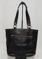 Front view showing zip pocket and overall condition