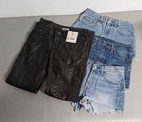 Harley-Davidson leather pants and three Levi’s denim shorts laid out