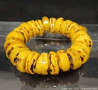 Top view of amber bead bracelet showing disc beads and inclusions