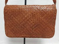 Front view of woven leather bag showing overall condition