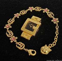 Bracelet and pin together on black background