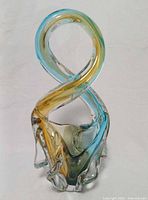 Front view of multicolored looped art glass sculpture