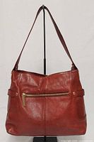 Front view of plum leather handbag showing zip pocket, strap and overall condition