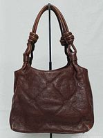 Front view of brown quilted leather satchel handbag