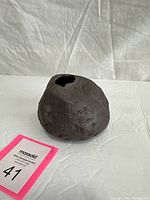 Front view of rough textured dark brown ceramic vase