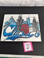 Full view of framed Chicago skyline artwork showing colors, frame and size tag