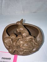 Front view showing planter shape and sculpted rabbit detail